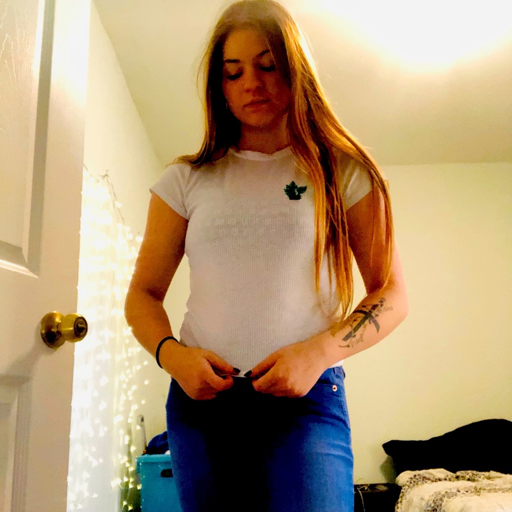 Short sleeve white shirt with plant detail on the front. No rips or stains.